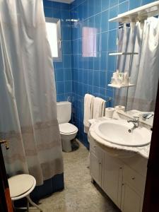 uma casa de banho com um lavatório, um WC e um chuveiro em Restaurante & Hostal El Volante em Moraleja