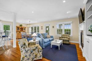 a living room with a blue couch and chairs at 24 Sea Mist Lane Chatham Cape Cod - - The Sea Mist in South Chatham
