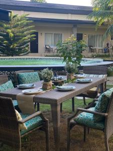 a table and chairs with plates on it next to a pool at Ariella Mangrove & Eco Resort by Hiverooms 