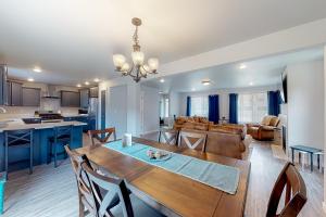 a dining room and living room with a table and chairs at Pelican and the Raven in Rockaway Beach