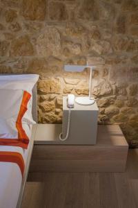 a bedroom with a bed and a lamp on a night stand at La Bandita Townhouse in Pienza