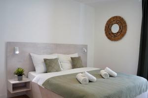 a bedroom with a large bed with pillows on it at Villa Nana Pag in Pag