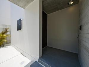 a hallway with a staircase with blue flooring at Onna Resort 海まで徒歩0秒 最大12名宿泊可 オーシャンビュー貸切ヴィラ in Nago +45 photos
