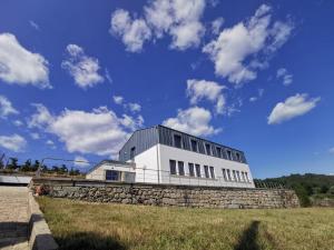 a white building on top of a stone wall at Casa da Escola in Vouzela