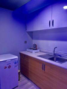 a kitchen with a sink and a refrigerator at Kuzey suite home in Trabzon