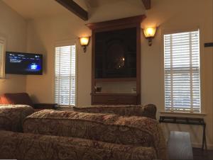 sala de estar con sofá y TV de pantalla plana en Golden Eagle Vacation Rentals - Orca Suite - Cottage #3 - ADA, en Trinidad