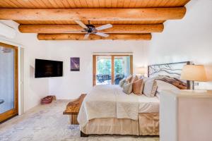 a bedroom with a bed and a ceiling fan at Casita Tres Hermanos in Santa Fe