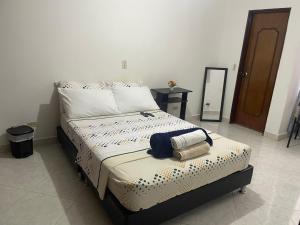 um quarto com uma cama com duas toalhas em M&N Alojamiento es una habitación en un apto em Medellín