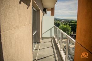 a balcony with a white refrigerator on the side of a building at Apart Design in Tartagal