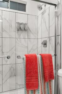 a bathroom with red towels on a shower at The Avalon - Pre Summer Sale! 25 Percent Off May! in Los Angeles