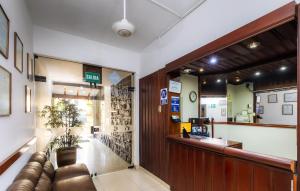 a waiting room with a couch and a bar at Hotel Portada Del Sol in Trujillo