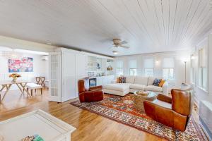a living room with a couch and a table at Bees Knees House in Boothbay Harbor