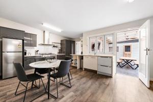 a kitchen with a table and chairs in a room at Azami - Charming Gilbert Cottage in Adelaide