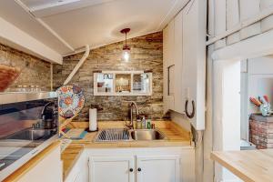 a kitchen with white cabinets and a sink at Cowboy Cabin Ranch in Colorado Springs