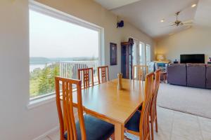 a dining room with a table and chairs and a large window at The Lookout in Union