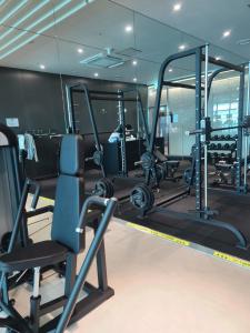 a gym with tread machines and a simulator at Harington Gwangan in Busan