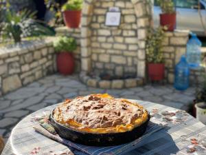 a pie sitting on top of a table at Vjosa Guest House in Memaliaj