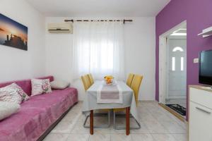 a living room with a purple couch and a table at Apartments by the sea Tkon, Pasman - 21391 in Tkon