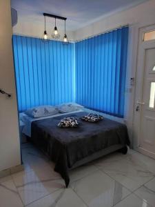 a bedroom with blue walls and a bed with two pillows at Apartments by the sea Tkon, Pasman - 21391 in Tkon