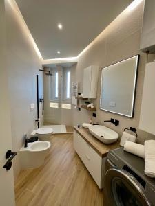 a bathroom with two sinks and a washing machine at Luxury Downtown - Milan MF Apartments in Milan