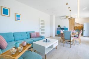 a living room with a blue couch and a table at Family friendly house with a swimming pool Plano, Trogir - 21403 in Prgomet