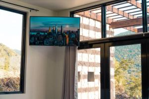 a room with a window with a view of a city at Enclave Villa V3 -Overlooking Pitons & Ocean ! Wow in Soufrière
