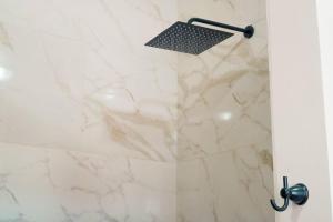 a shower with a white marble shower stall at Enclave Villa V3 -Overlooking Pitons & Ocean ! Wow in Soufrière