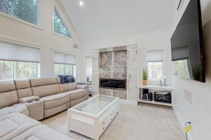 a living room with a couch and a fireplace at Webb River House in Rumford