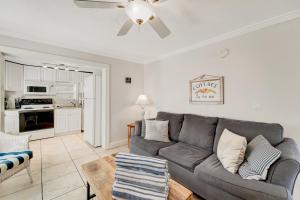 a living room with a couch and a ceiling fan at Casa Del Sol B in Bradenton Beach