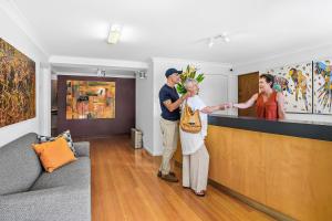 a man and a woman standing in a living room at Park Ridge Retreat in Gerringong