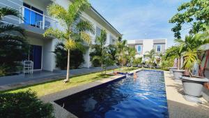 a swimming pool in front of a building at Sapphire Boutique Resort in Panglao