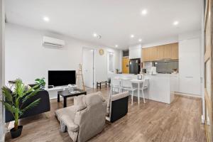 a living room with a kitchen and a dining room at Rose - The Fringe Escape in Bowden