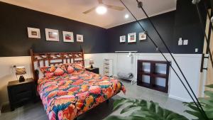 a bedroom with a bed with a colorful comforter at The Settler, Port Pirie in Port Pirie