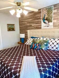 a bedroom with a bed and a ceiling fan at Cape Canaveral Senior Condominium in Cape Canaveral