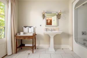 a bathroom with a sink and a mirror at The Old Bank House in Niagara on the Lake