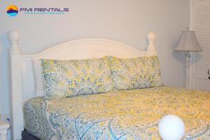 a bedroom with a bed with a white headboard at Marina Pinacate B-101 in Puerto Peñasco