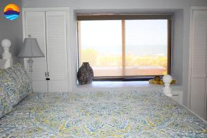 a bedroom with a large bed with a large window at Marina Pinacate B-101 in Puerto Peñasco