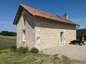 a small brick building with a bench next to it at Maison isolée avec piscine privée et spa, Charente - FR-1-653-4 in Montignac-le-Coq