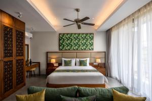 a bedroom with a large bed and a couch at Angkor Grace Residence & Wellness Resort in Siem Reap