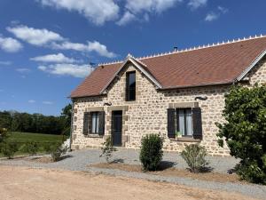 a stone house with a brown roof at Gîte Ygrande, 4 pièces, 8 personnes - FR-1-489-433 in Ygrande