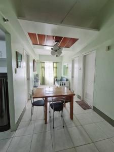a dining room with a wooden table and chairs at Modern & Spacious 2BR Condo with Netflix & Pool Acess in San Juan Manila in Manila