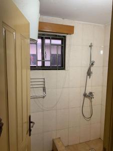 a bathroom with a shower and a window at 2 Bedroom @ Devtraco Estates -Tema Comm 25 in Tema