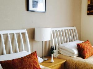 
a bed room with a white bedspread and pillows at The Upper Largo Hotel & Restaurant in Lundin Links
