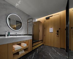 a bathroom with a sink and a mirror at Hilton Garden Inn Jiaxing Xiuzhou in Jiaxing