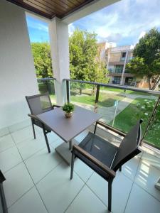 a table and chairs on a balcony with a view at Iloa Residence Ap 103 K Barra de São Miguel AL in Barra de São Miguel