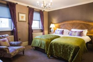 A bed or beds in a room at Muckrach Country House Hotel 