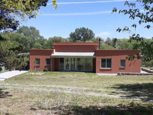 a house with a large yard in front of it at Casa de Campo con Bosque y Pileta in Tandil