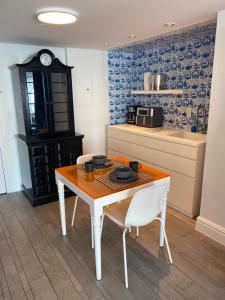 a kitchen with a table and two chairs and a counter at Bay view king suite with balcony in Miami Beach