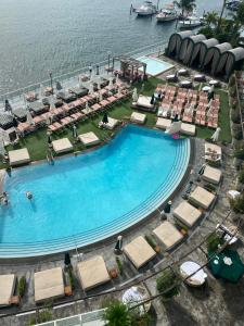 an overhead view of a large swimming pool with chairs and water at Bay view king suite with balcony in Miami Beach