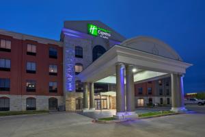 a hotel with a sign on the front of a building at Holiday Inn Express Hotel and Suites Katy, an IHG Hotel in Katy